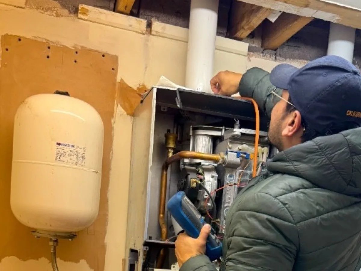 Engineer running a flue gas analysis during a boiler service
