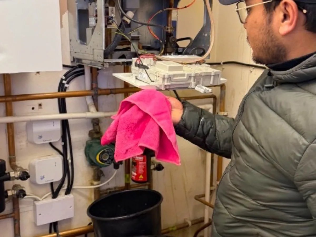 Engineer working inside an open boiler on an urgent callout